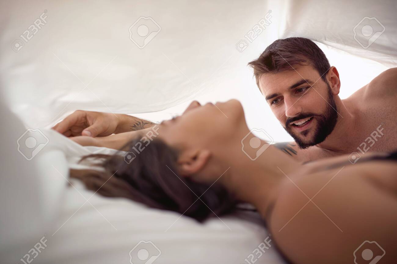 man and woman in bed making love