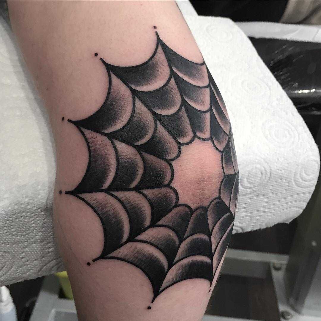 spiderweb tattoo on elbow