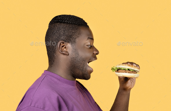 black guy eating hamburger