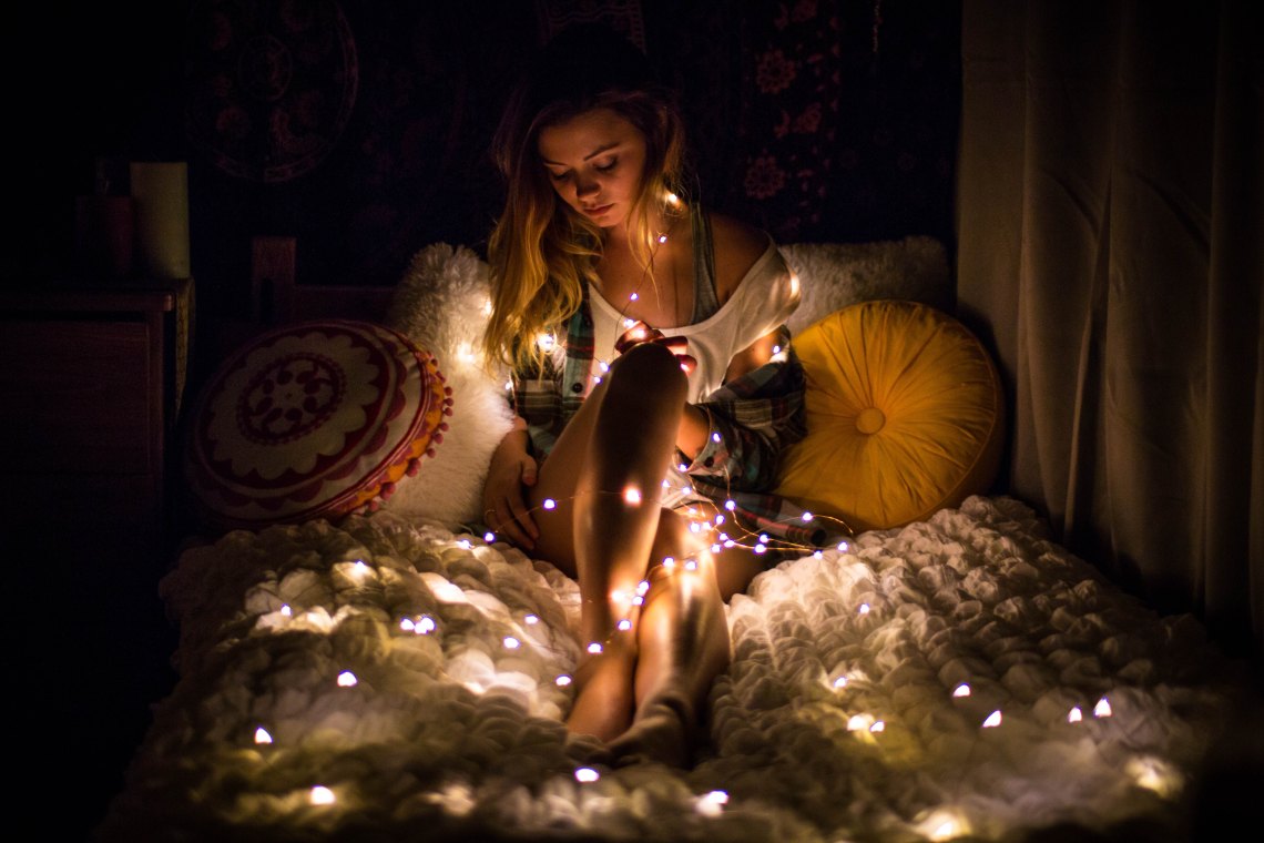 girl wrapped in christmas lights