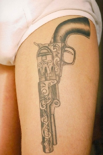 amir shahrul add pistol tattoo on hip photo