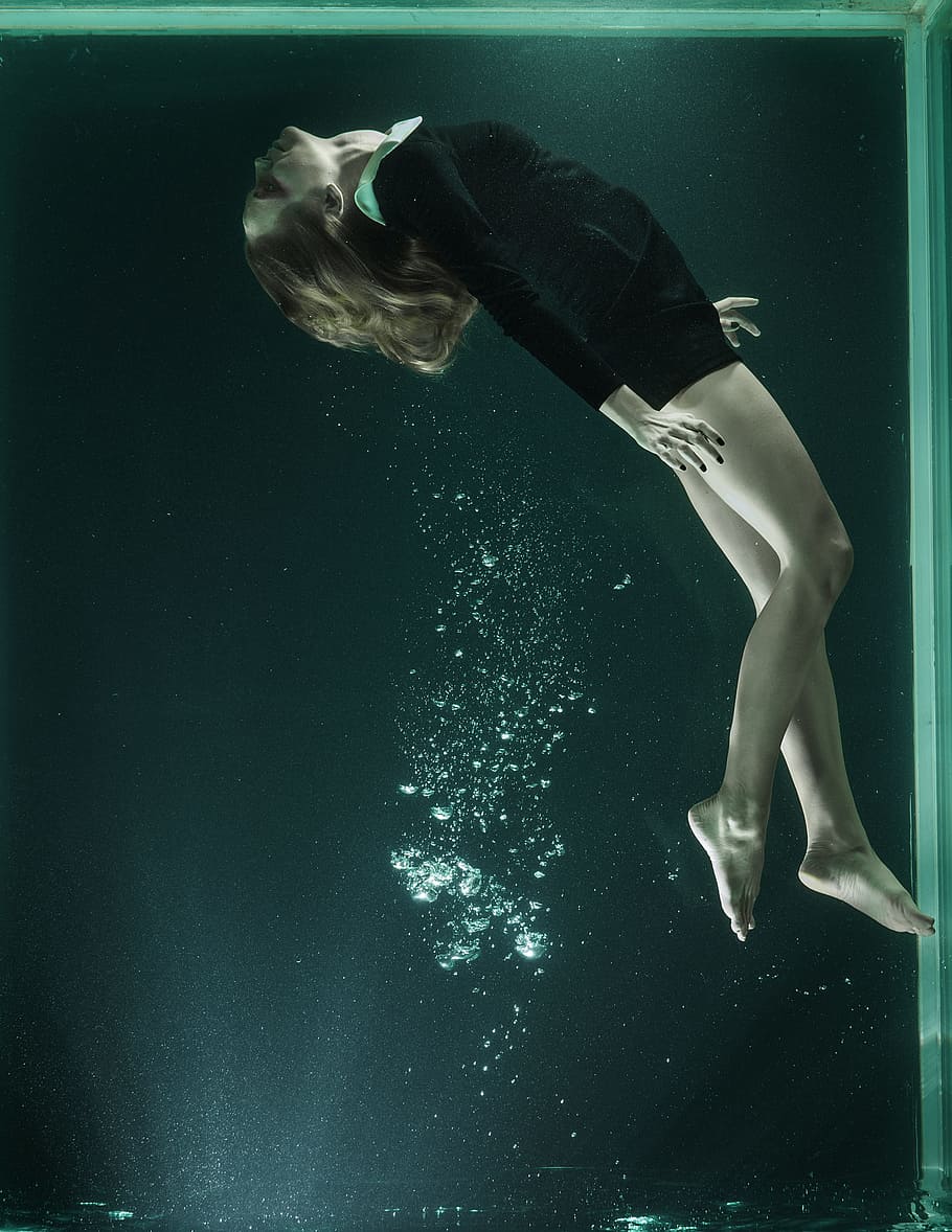 woman underwater in tank